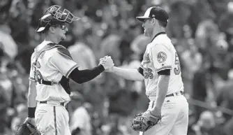  ?? GAIL BURTON/ASSOCIATED PRESS ?? Orioles catcher Caleb Joseph, left, and reliever Darren O'Day celebrate their win over the Tigers. O’Day earned his second save of the season after presumptiv­e closer Brad Brach entered in the sixth inning.