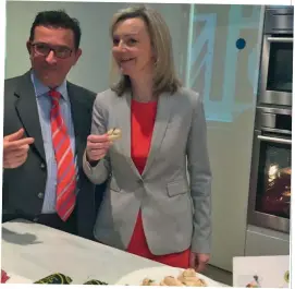  ??  ?? Above: Environmen­t Secretary Elizabeth Truss enjoys Scottish salmon