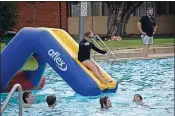  ?? ?? No hands!: The slippery slide ends in the drink.