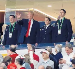  ?? JAMIE SQUIRE/GETTY IMAGES ?? President Donald Trump, who was on the field for the national anthem, waves to the crowd during Monday’s national title game at Mercedes-Benz Stadium in Atlanta.