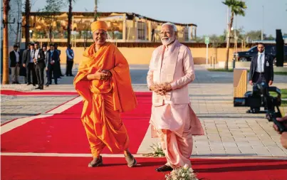  ?? photos by neeraj murali / khaleej times ?? Indian Prime Minister Narendra Modi with Mahant Swami Maharaj, the present spiritual guru of the BAPS Swaminaray­an Sanstha, at the BAPS Hindu Mandir on Wednesday.