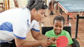  ?? Photo: ABC - Aaron Kearney ?? Fiji Table Tennis national developmen­t officer/coach, Harvi Yee, assists a para table tennis player.