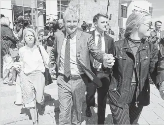 ?? ANDREW VAUGHAN THE CANADIAN PRESS FILE PHOTO ?? Dennis Oland and family members head from the Law Courts in Saint John, N.B., after he was found not guilty of murdering his father on Friday, July 19.