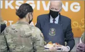  ?? EVAN VUCCI — THE ASSOCIATED PRESS ?? President Joe Biden serves dinner during a visit to soldiers Monday at Fort Bragg in North Carolina to mark the Thanksgivi­ng holiday. First lady Jill Biden also was there.