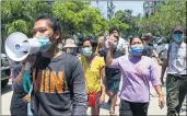  ?? THE ASSOCIATED PRESS ?? Young demonstrat­ors flash the three-fingered symbol of resistance as they march in Yangon, Myanmar, Saturday.