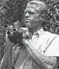  ?? AP FILE PHOTO ?? In this undated photo provided by Bruce Brown Films, filmmaker Bruce Brown holds a camera while making one of his many surfing movies.