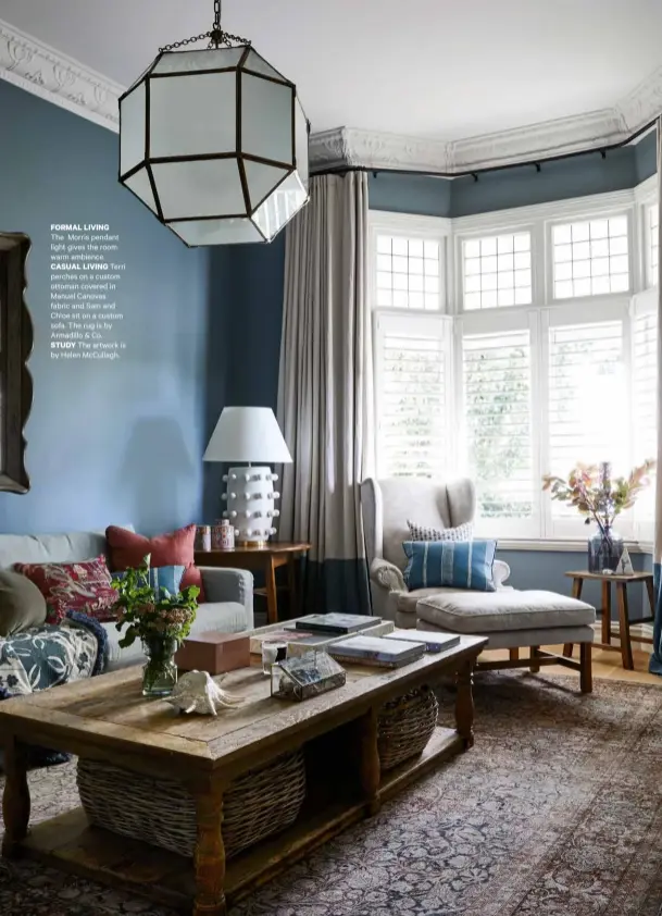  ??  ?? FORMAL LIVING
The Morris pendant light gives the room warm ambience.
CASUAL LIVING Terri perches on a custom ottoman covered in Manuel Canovas fabric and Sam and Chloe sit on a custom sofa. The rug is by Armadillo & Co.
STUDY The artwork is by Helen McCullagh.