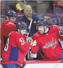  ?? AP PHOTO ?? CAPPING IT OFF: Tom Wilson celebrates with teammates Alex Ovechkin (back left) and Chandler Stepherson after his empty net goal in Washington’s victory.