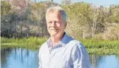  ?? RICH POPE/ORLANDO SENTINEL ?? Orlando attorney Steven Meyers stands next to the waterways of Lake Hart and Lake Mary Jane that he is suing to protect.