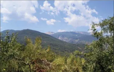  ?? CAIN BURDEAU VIA AP ?? This Aug. 4, 2018 photo shows a view of the Madonie Mountains in northern Sicily. The Madonie are a world apart from Sicily’s packed summertime beaches and busy coastlines. This wild region of Sicily is known for its towns atop hills and mountains, its delicious food, ornate churches and friendly people.