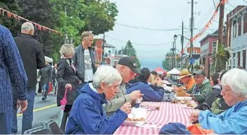  ??  ?? The 320-foot lunch table was filled with people from all over at the Festival of Flavours September 13.