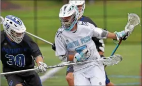  ?? BOB RAINES — DIGITAL FIRST MEDIA ?? North Penn’s Eric Diamond protects his stick from Great Valley’s Drew German.