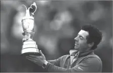  ?? SCOTT HEPPELL / The Associated Press ?? Rory McIlroy holds up the Claret Jug trophy after winning the British Open on Sunday.
