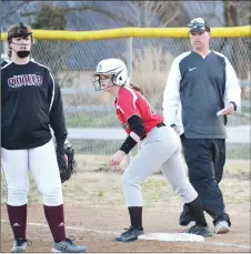  ?? TIMES photograph by Annette Beard ?? Lady Blackhawk softball head coach Josh Reynolds checked his notes while coaching beside first base recently.