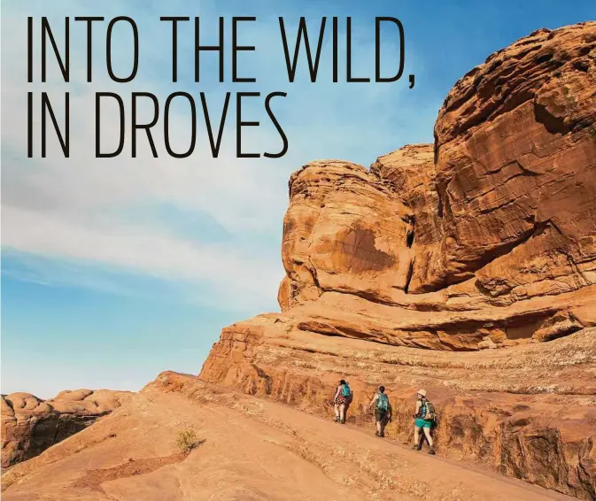  ??  ?? Travelers hike to Delicate Arch at Arches National Park in Utah last month. Decades ago, the pioneering writer Edward Abbey immortaliz­ed the then-empty Arches National Park, admiring its solitude.