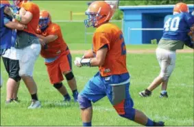  ?? JOHN BREWER - ONEIDA DAILY DISPATCH ?? Oneida senior Vinny Leibl weaves his way through the defense after securing a catch during practice on Monday, Aug. 20.