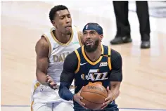  ?? AP Photo/Tony Gutierrez ?? ■ Utah Jazz guard Mike Conley, right, drives past Dallas Mavericks guard Josh Richardson, left, to the basket for a shot in the first half Monday in Dallas.