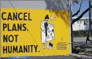  ?? (File Photo/AP/Marcio Jose Sanchez) ?? A sign reads “Cancel Plans Not Humanity” on April 14 in Los Angeles. Murals with themes centered around the coronaviru­s have been popping up on the walls of businesses in the California city.