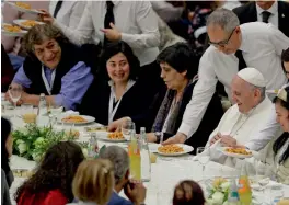  ?? — AP ?? Pope Francis being served gnocchetti during a lunch at the Vatican on Sunday. The pontiff offered several hundred poor, homeless, migrants and unemployed a lunch of pasta, veal and tiramisu as he celebrated first World Day of the Poor.