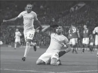  ?? DAVE THOMPSON, THE ASSOCIATED PRESS ?? Manchester City’s Nicolas Otamendi salutes after scoring his side’s second goal against Manchester United at Old Trafford Stadium in Manchester, England, on Sunday. City won the Manchester derby, 2-1.