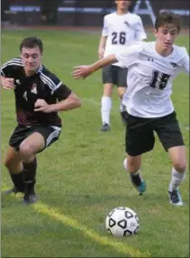  ?? DIGITAL FIRST MEDIA FILE PHOTO ?? Upper Dublin’s Christophe­r Kenney chases down a loose ball near Abington’s Liam Campbell.