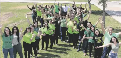  ?? ?? Imperial Valley College staff and students come together to form a green mental health awareness ribbon.