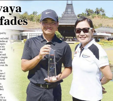  ??  ?? Miguel Tabuena holds his trophy as he poses with ICTSI public relations head Narlene Soriano after claiming the ICTSI Anvaya Cove Invitation­al crown yesterday.