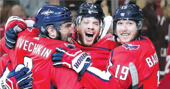  ?? THE ASSOCIATED PRESS ?? Capitals defenceman John Carlson, centre, celebrates with teammates Alex Ovechkin and Nicklas Backstrom after scoring against the Golden Knights on Monday.