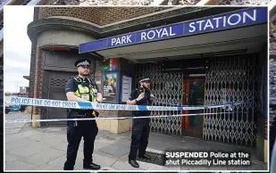  ?? ?? SUSPENDED Police at the shut Piccadilly Line station