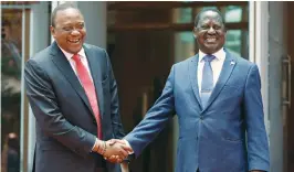  ?? (Thomas Mukoya/Reuters) ?? THE HANDSHAKE. Kenyan President Uhuru Kenyatta (left) greets opposition leader Raila Odinga after addressing a news conference in Nairobi on March 9.