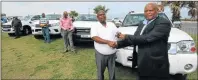  ?? Picture: LULAMILE FENI ?? SET UP: Cogta MEC Fikile Xasa hands a car key to designated medical officer Siboniwe Mahleka at the 2017 customary initiation summer season media launch in East London yesterday