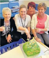  ??  ?? ●● Staff members Mrs Debbie Brinkhurst, Mrs Mel Sharratt, Mrs Kim Nesbit and Mrs Mandy Corrigan cut the birthday cake