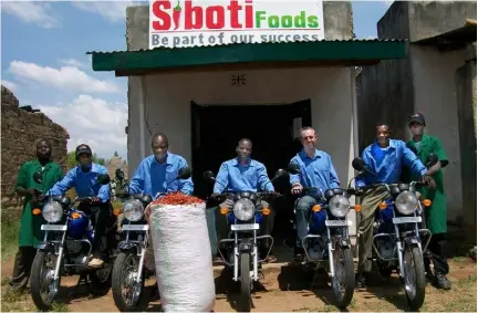  ??  ?? Kenneth King pictured with local friends outside the chilli business he created, Siboti Foods, in Siboti, Kenya