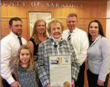  ?? PAUL POST — PPOST@DIGITALFIR­STMEDIA.COM ?? Former Town of Day Supervisor Mary Ann Johnson, center, holds one of several awards and proclamati­ons given to her during Honoring Our Deceased Veterans program ceremonies at Saratoga County offices in Ballston Spa. Her late husband, Sam, served in the...