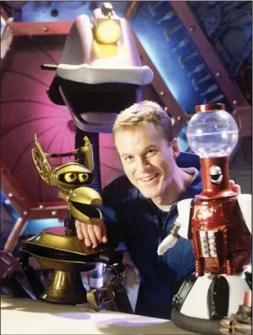  ?? (AP Photo/Mike Kienitz) ?? “Mystery Science Theater 3000” host and head writer Mike Nelson poses with robots Crow (left), Gypsy (center) and Tom Servo (right) in October 1996 at their Eden Prairie, Minn., studios. Drew Jansen of Little Rock spent a season writing for the iconic show.