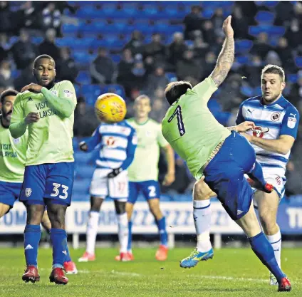  ??  ?? Late leveller: Lee Tomlin (No 7) fires in a shot that hits the bar and bounces down over the line to earn Cardiff a point