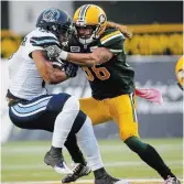  ?? JEFF MCINTOSH THE CANADIAN PRESS FILE PHOTO ?? Aaron Grymes, right, would “like to help continue to grow this game and leave it in a better place than I found it and make sure the next Aaron Grymes can enjoy a 10-year career and have the next transition available.”