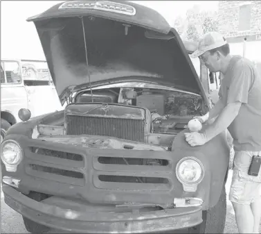  ?? COURTESY PHOTO ?? Doug Hutchens, Chamber of Commerce member and one of the coordinato­rs of the Chicken Rod Nationals, looks over his 1956 Studebaker pickup he brought to last year’s event. The 2013 car show is set for 9 a.m. to 3 p.m. on Saturday on the downtown square...