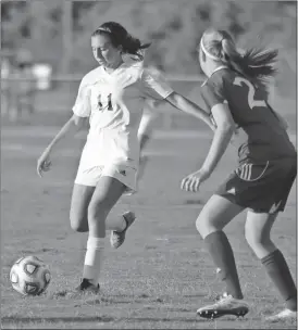  ??  ?? Jeremy Stewart / Rome News-Tribune Unity Christian’s Hannah Eddins (left) moves the ball around Lanier Christian’s Jana Butler during a match in the GICAA Division II-A state semifinals Tuesday at Grizzard Park.