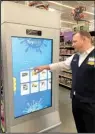  ?? Arkansas Democrat-Gazette/ ROBBIE NEISWANGER ?? Store manager James Schroder demonstrat­es a large touch screen in the toy department at a Wal-Mart supercente­r in Orlando, Fla. The touch screen gives customers a chance to sift through the retailer’s in-store and online catalog.