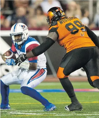  ?? PAUL CHIASSON/THE CANADIAN PRESS FILES ?? Montreal Alouettes quarterbac­k Kevin Glenn is sacked by B.C. Lions defensive end Jabar Westerman during fourth quarter CFL football action last August in Montreal.