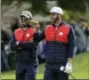  ?? CHRIS CARLSON - AP ?? United States’ Dustin Johnson talks to United States vice-captain Tiger Woods on the fifth hole during a practice round for the Ryder Cup golf tournament Tuesday at Hazeltine National Golf Club in Chaska, Minn.