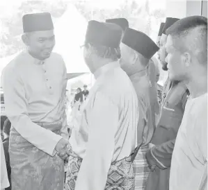  ??  ?? AZIS bersalaman ketika tiba di majlis itu.