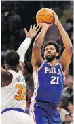  ?? SETH WENIG/ASSOCIATED PRESS ?? Joel Embiid helped Philadelph­ia score a win in New York Sunday.