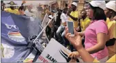  ??  ?? STAND-OFF: Pro-Zuma protesters, allegedly members of the ANC Youth League, destroy a gazebo set up by antiZuma marchers in Pietermari­tzburg yesterday.