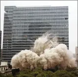  ??  ?? Ashbel Smith Hall, the 10-story former headquarte­rs for the University of Texas System, implodes in downtown Austin on Sunday. The hall served the university system for more than 40 years but took just seconds to be erased from the city skyline. See...