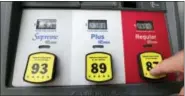  ?? ALAN DIAZ — THE ASSOCIATED PRESS ?? In this Tuesday photo, a motorist prepares to select regular gas at a pump at a Chevron station in Miami. Gas prices are still quite low, historical­ly speaking, and were fairly steady in 2017. But 2018 may be a bit more rocky, according to Tom Kloza,...