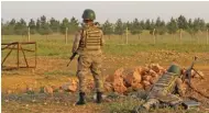  ?? - Reuters ?? VIGIL: Turkish soldiers stand guard in the border town of Akcakale on the Turkish-Syrian border in Sanliurfa province, Turkey, on Thursday.