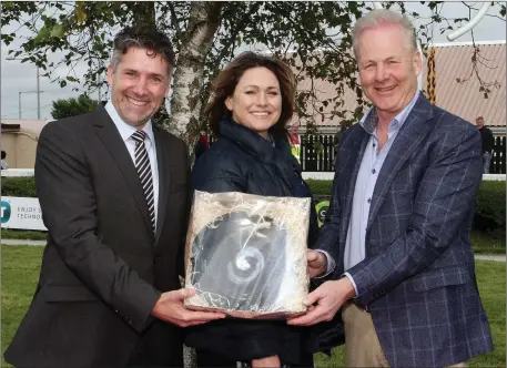  ??  ?? Jurgen Deutschman­n (MD Sulzer Pumps) and his wife Emel presented Paddy Redmond from Gorey, owner of the winning horse ‘A Rated’, which was ridden by Barry O’Neill, with his prize at the Wexford races recently.