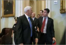  ?? J. SCOTT APPLEWHITE — THE ASSOCIATED PRESS ?? Vice President Mike Pence, left, talks with Sen. Todd Young, R-Ind., as they enter a Senate Republican policy luncheon at the Capitol in Washington, Tuesday.